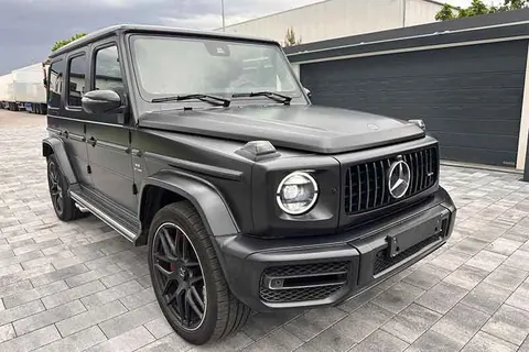 Schwarze Mercedes-AMG G-Klasse auf gepflastertem Hof